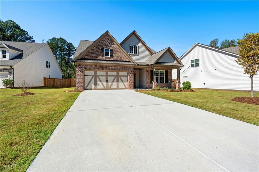Front exterior of a new home in Candleberry Place, Sharpsburg, GA, highlighting curb appeal (Image 21).