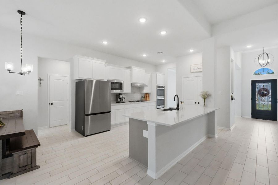 Modern kitchen with a large island, stainless steel appliances, and plenty of space for cooking and gathering.
