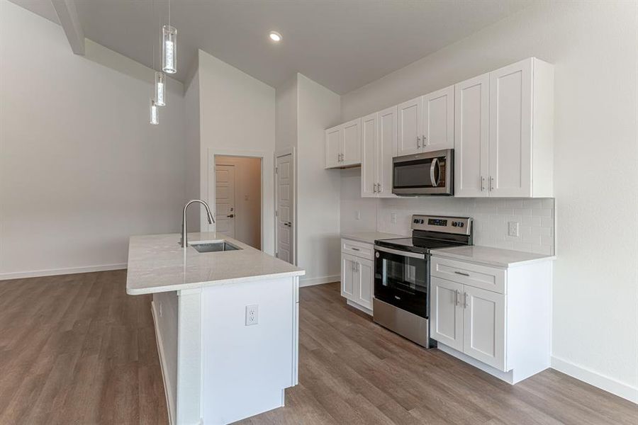 Kitchen with sink in bar, pantry and utility room with garage entry