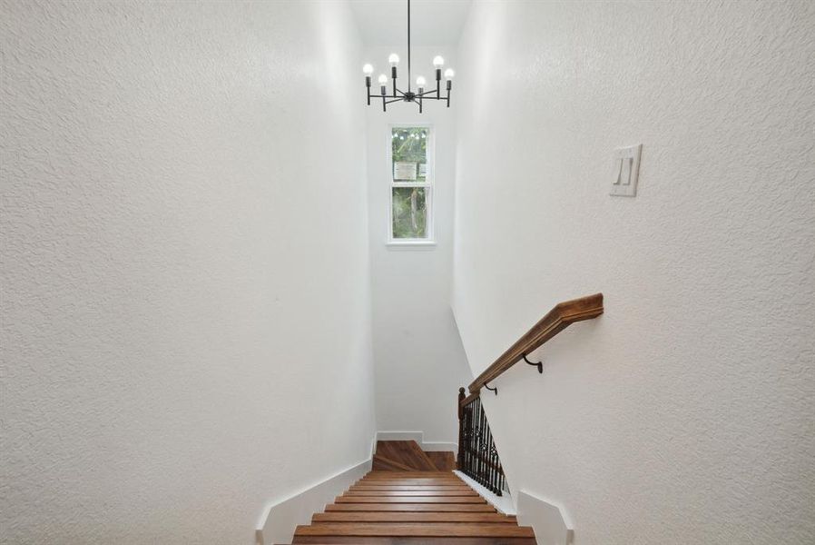 Stairway with a notable chandelier