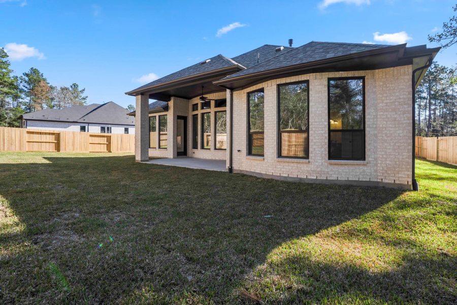 Exterior details and patio area of a home in The Woodlands Hills, Willis (Image 22).