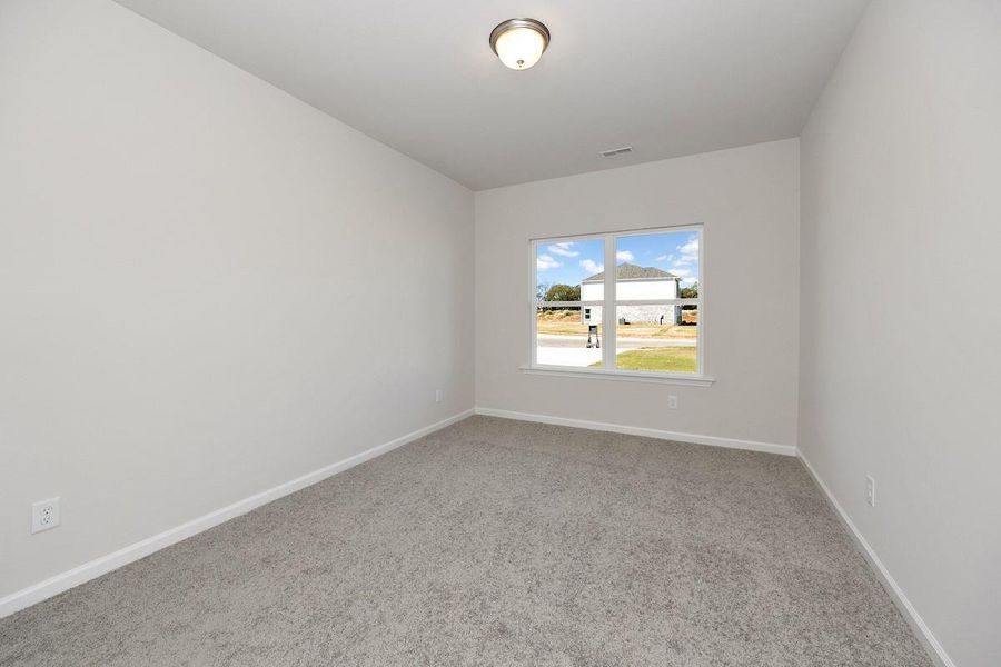 The Avery- Bedroom 2. Home under construction. Sample floor plan photo used for illustrative purposes only. Upgrades, selections options, and colors will vary.