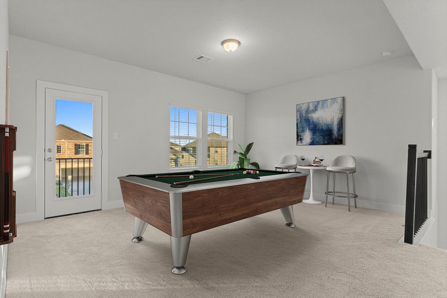 The game room upstairs is a fantastic bonus space—bright, open, and versatile. With plush carpeting, tall windows, and direct balcony access, to enjoy the evening stars. *Staged Photo* The game room upstairs is a fantastic bonus space—bright, open, and versatile. With plush carpeting, tall windows, and direct balcony access, to enjoy the evening stars. *Staged Photo*