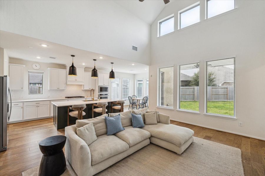 A corner view of the family room showcases the home’s open-concept design, where the kitchen, breakfast nook, and living area flow seamlessly together—ensuring you’re part of the conversation no matter where you are.