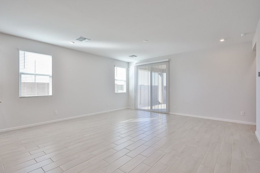 A room with a wood floor and windows. A room with a wood floor and windows.