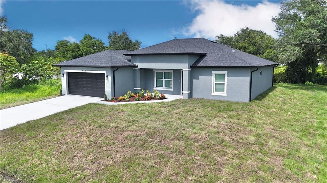 Front exterior of a new home in , Port Charlotte, FL, highlighting curb appeal (Image 1).