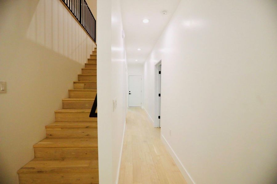 Stairs featuring hardwood / wood-style floors and recessed lighting