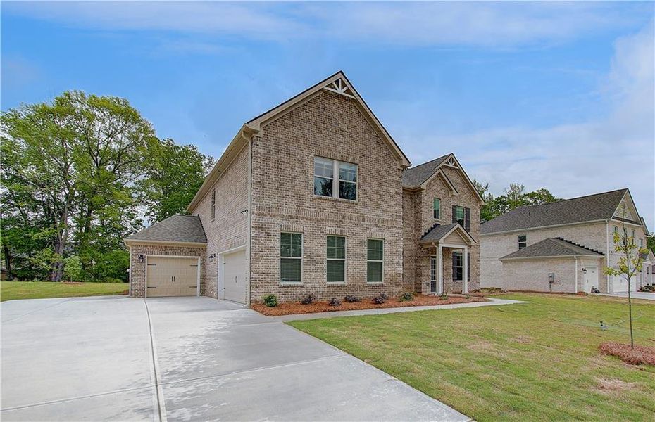 Front exterior of a new home in Cambria at Traditions, Hampton, GA, highlighting curb appeal (Image 19).