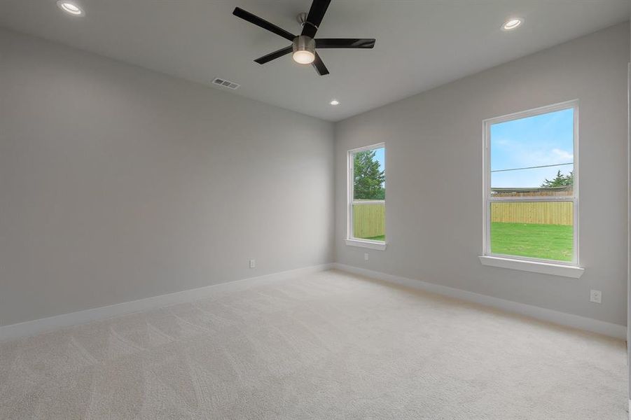 Empty room featuring baseboards, a ceiling fan, light carpet, and recessed lighting