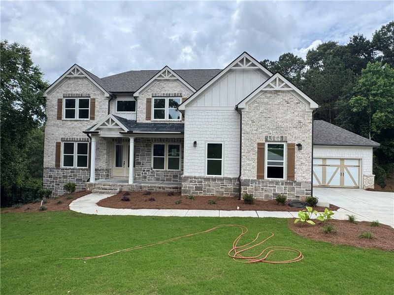 Front exterior of a new home in , Flowery Branch, GA, highlighting curb appeal (Image 2). Front exterior of a new home in , Flowery Branch, GA, highlighting curb appeal (Image 2).