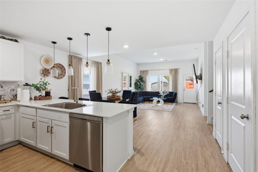 View from the edge of the kitchen  towards the open concept kitchen, dining and living room.