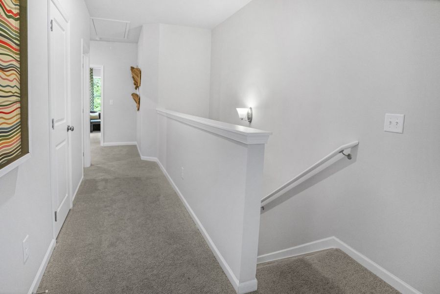 This picture is from our furnished and decorated model home in the community.  Window placement and color scheme may vary per unit location.  Ask agent for more specific details regarding colors and options.  Staircase will feature additional windows