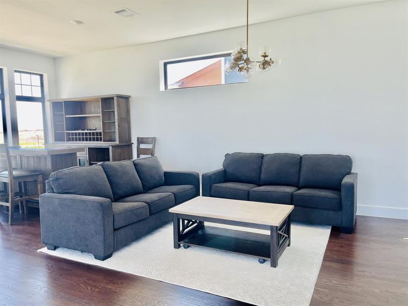 Living room featuring dark wood finished floors and plenty of natural light Living room featuring dark wood finished floors and plenty of natural light