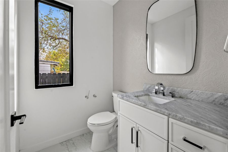 Bathroom featuring vanity and light marble finish floors