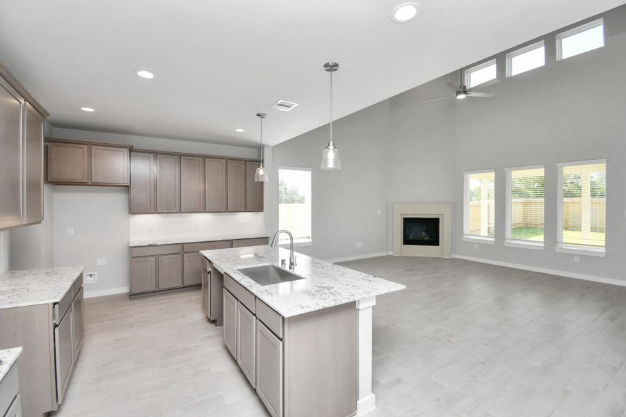 This kitchen is truly a chef's dream! This haven Boasts high ceilings, recessed & pendant lighting, stained wood cabinets, granite countertops, stainless steel appliances, a modern tile backsplash. All of this overlooks your expansive family room, creating a perfect space for culinary delights and family gatherings. Sample photo of completed home with similar floor plan. Actual colors and selections may vary. This kitchen is truly a chef's dream! This haven Boasts high ceilings, recessed & pendant lighting, stained wood cabinets, granite countertops, stainless steel appliances, a modern tile backsplash. All of this overlooks your expansive family room, creating a perfect space for culinary delights and family gatherings. Sample photo of completed home with similar floor plan. Actual colors and selections may vary.