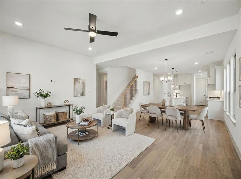 Open-concept living space featuring wood-finish flooring, recessed lighting, and a modern ceiling fan