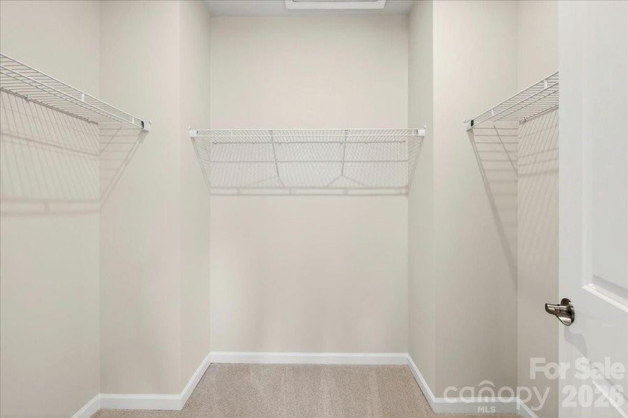 Large primary walk-in closet Large primary walk-in closet