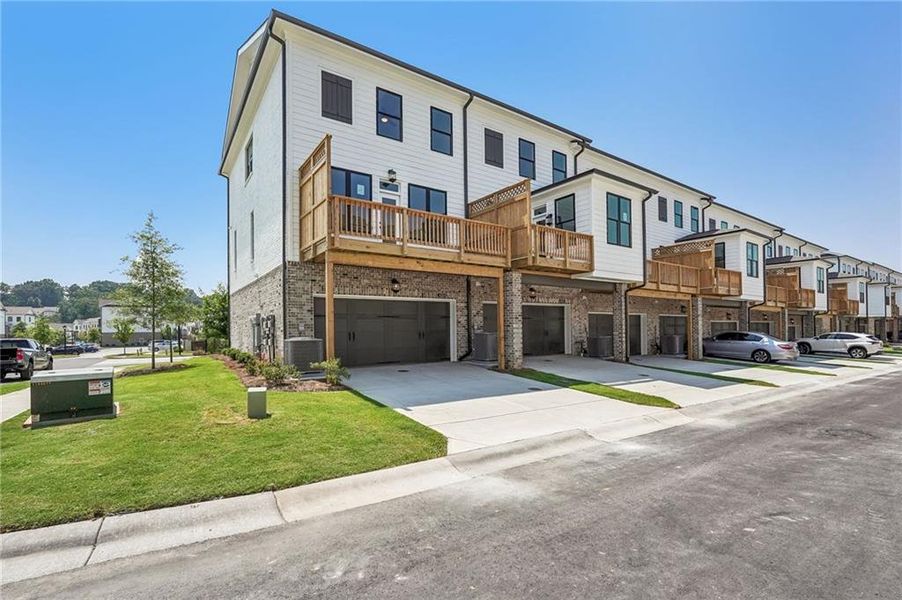 Front exterior of a new home in Millcroft Townhomes, Buford, GA, highlighting curb appeal (Image 2). Front exterior of a new home in Millcroft Townhomes, Buford, GA, highlighting curb appeal (Image 2).