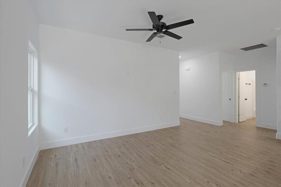 Unfurnished room featuring ceiling fan and light hardwood / wood-style floors