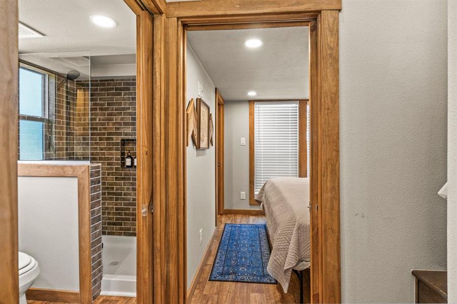 Full bathroom featuring light wood-type flooring, a shower stall, ensuite bathroom, recessed lighting, and healthy amount of natural light