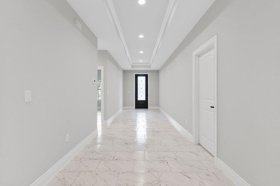 Beautiful entryway looking toward the front door, half bath to the right.