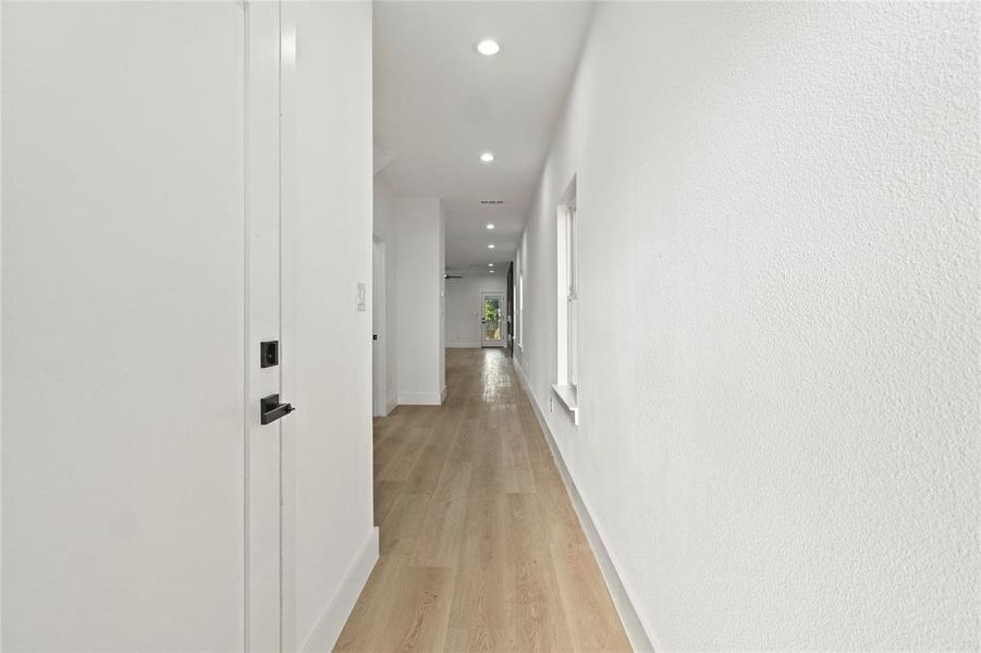 Hall with recessed lighting and light wood-style flooring Hall with recessed lighting and light wood-style flooring