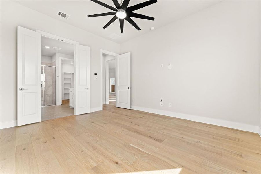 Unfurnished bedroom featuring ceiling fan and light hardwood / wood-style floors