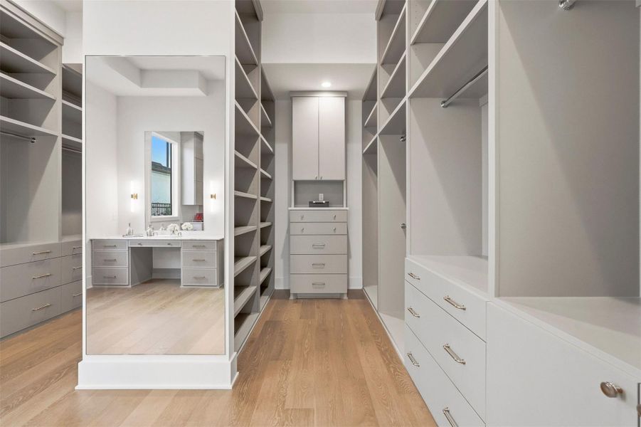 Inside another set of reclaimed wooden doors from Round Top, your Texas-sized closet with two paralleled hallways flanked by custom shelving. Notice a secondary vanity (in addition to the one in the bathroom). Inside another set of reclaimed wooden doors from Round Top, your Texas-sized closet with two paralleled hallways flanked by custom shelving. Notice a secondary vanity (in addition to the one in the bathroom).