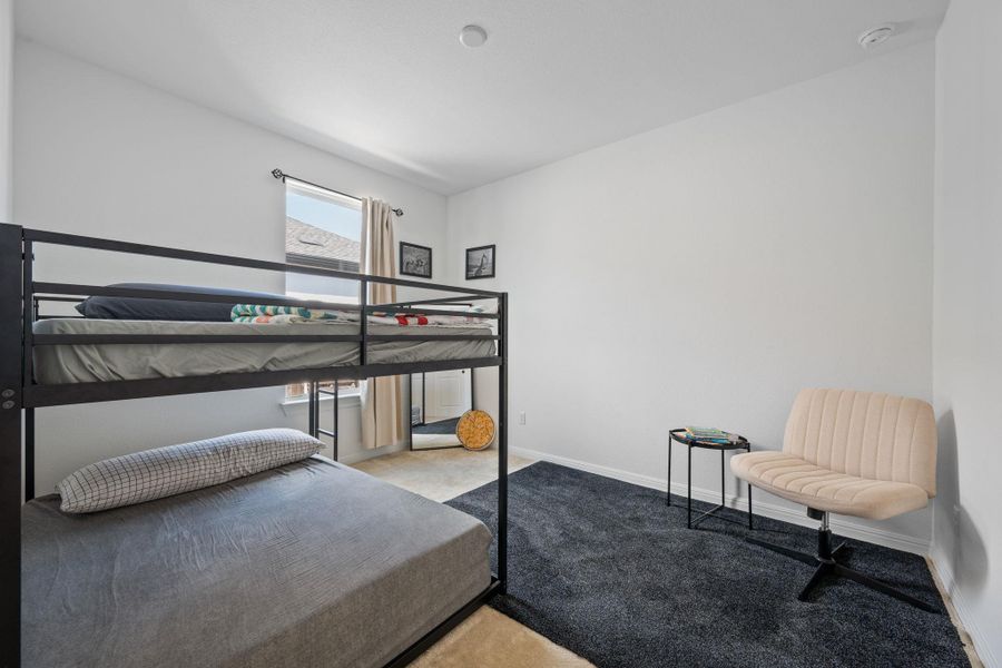 Bedroom with light colored carpet and baseboards Bedroom with light colored carpet and baseboards