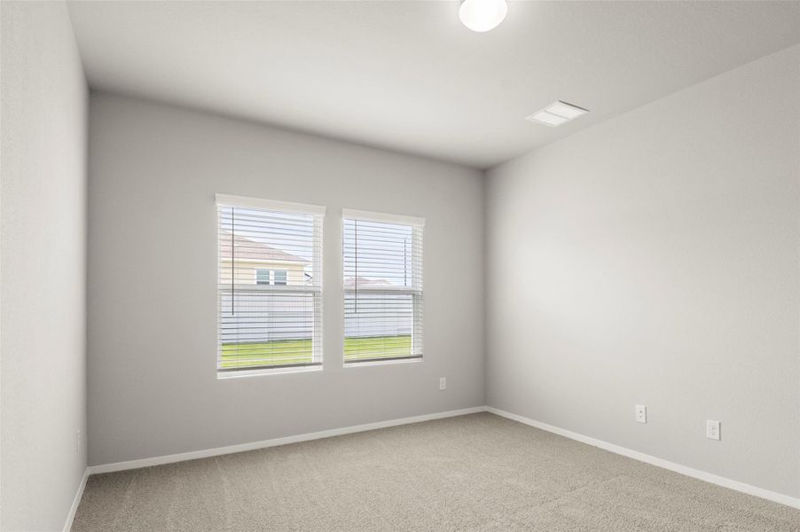Carpeted empty room featuring baseboards