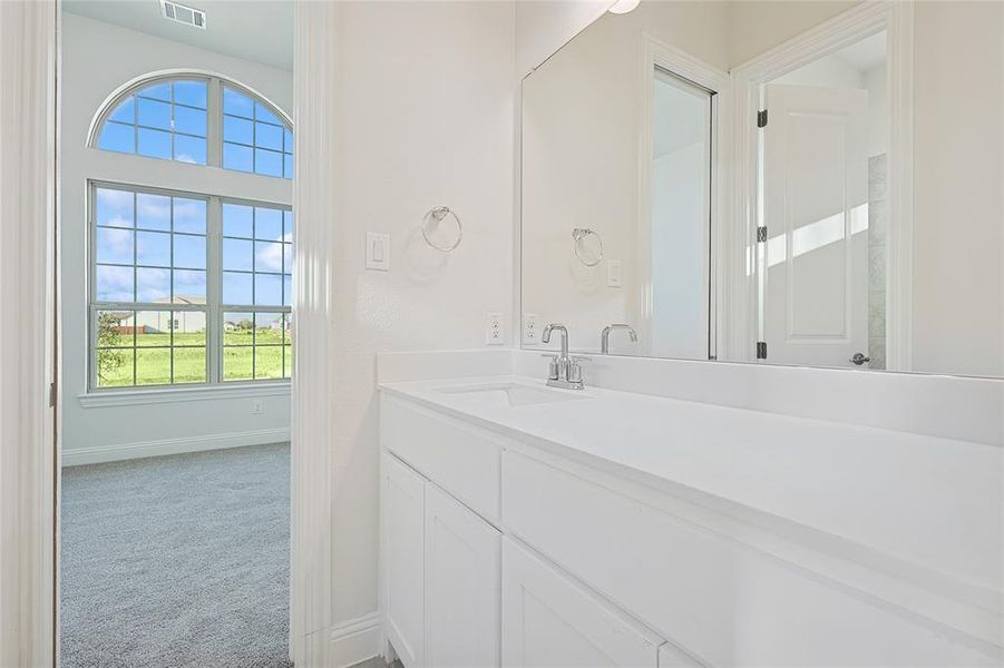 Unfurnished bedroom with carpet, a closet, and ensuite bath Unfurnished bedroom with carpet, a closet, and ensuite bath