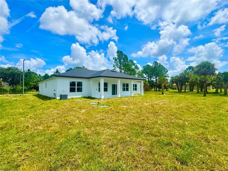 Front exterior of a new home in , Palm Bay, FL, highlighting curb appeal (Image 25).