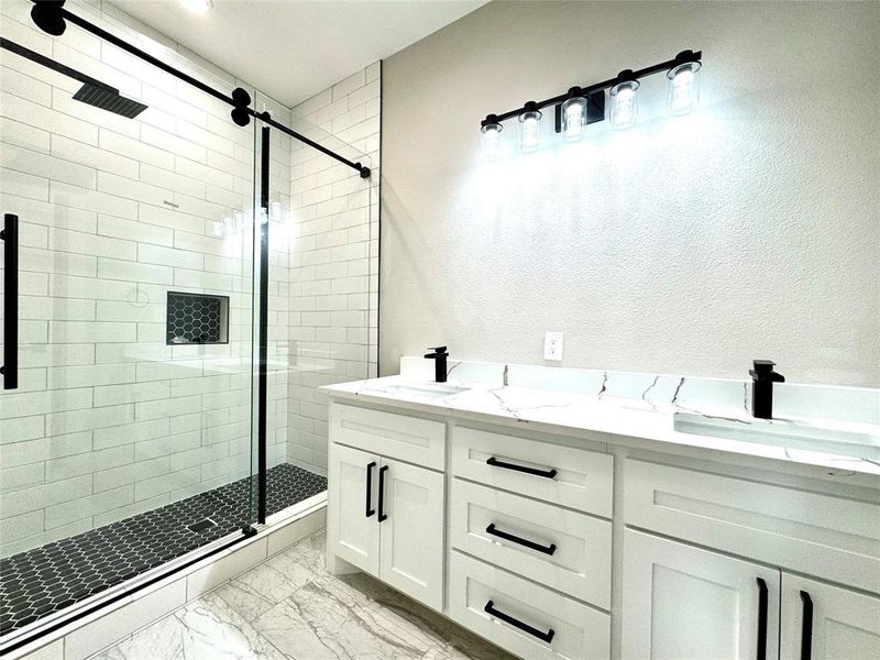 Custom cabinetry and walk in shower.