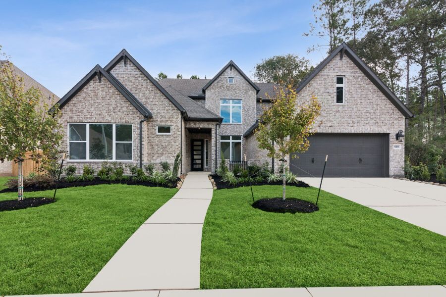 Front exterior of a new home in ARTAVIA 65' Homesites, Conroe, TX, highlighting curb appeal (Image 1).