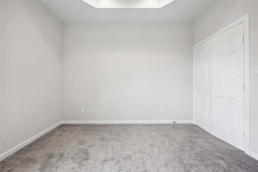 Unfurnished bedroom with carpet flooring, baseboards, and a closet Unfurnished bedroom with carpet flooring, baseboards, and a closet