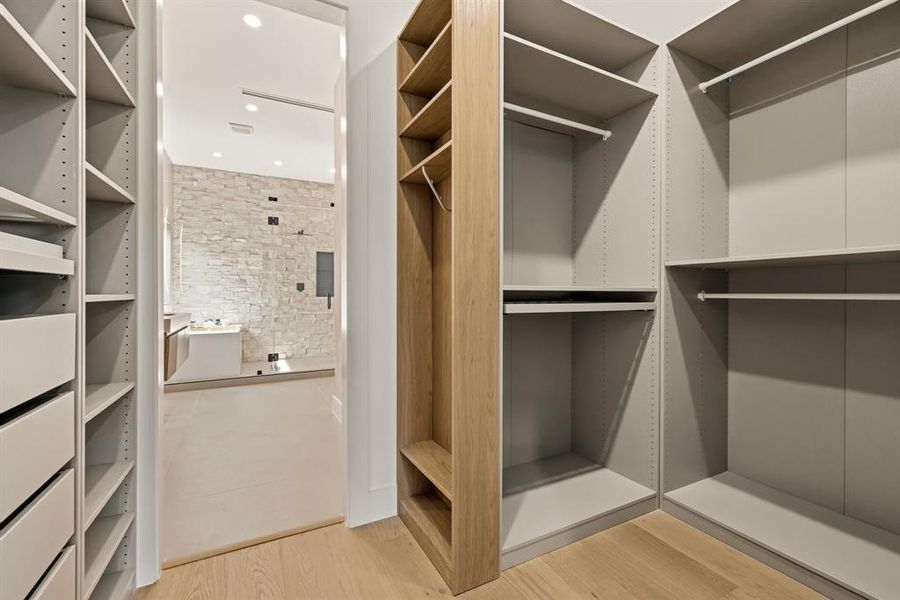 Custom-designed closet system featuring extensive shelving and hanging rods