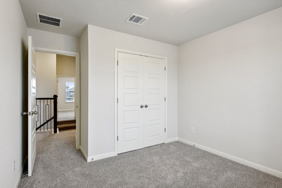 Guest bedroom in the Red River floorplan at a Meritage Homes community.