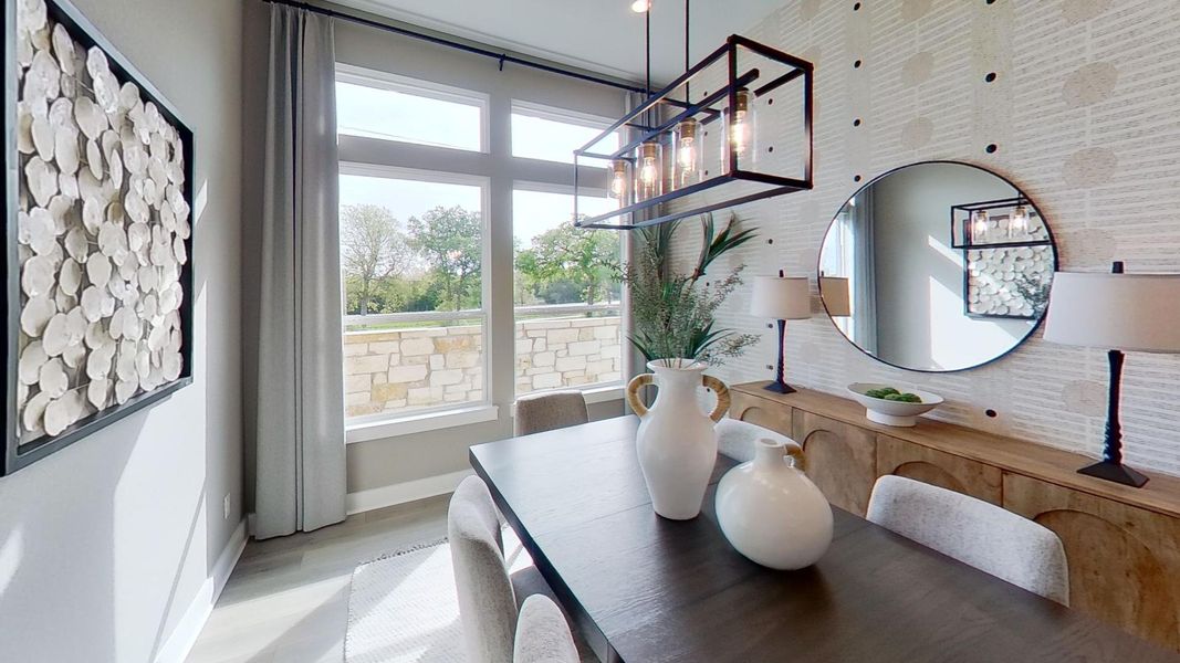 Dining room with baseboards and light wood-style flooring