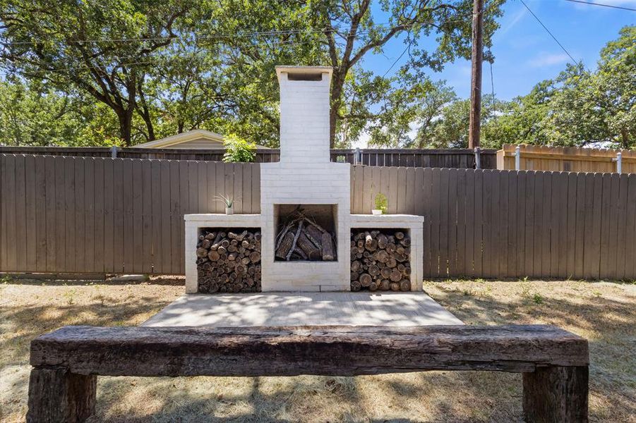 View of patio / terrace featuring exterior fireplace View of patio / terrace featuring exterior fireplace