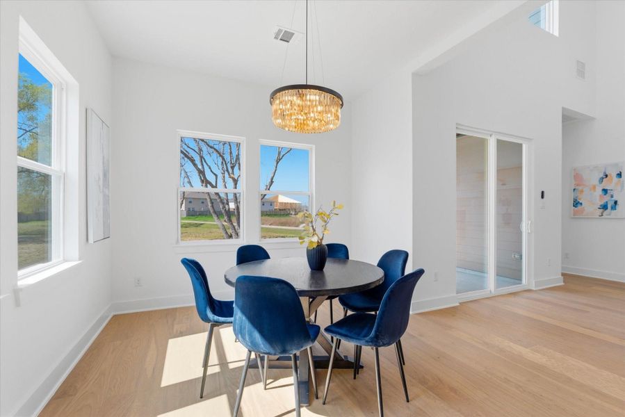Bright dining space featuring peaceful outdoor views and the added privacy of having no rear neighbors.