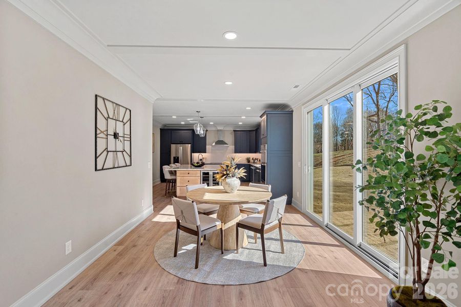 A convenient casual dining area, just steps from the Kitchen, offers peaceful views of the professionally landscaped backyard and gorgeous mature trees.
