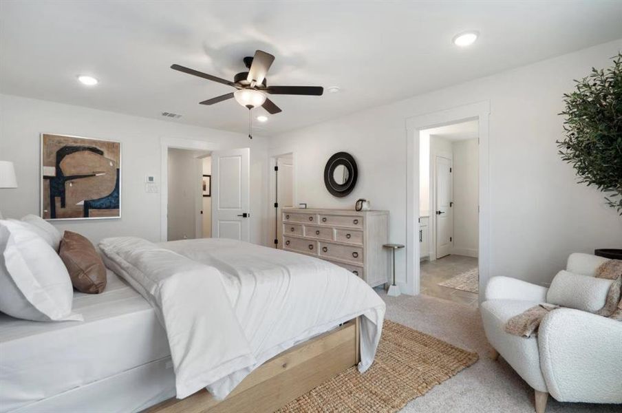 Bedroom featuring light colored carpet, a ceiling fan, and recessed lighting
