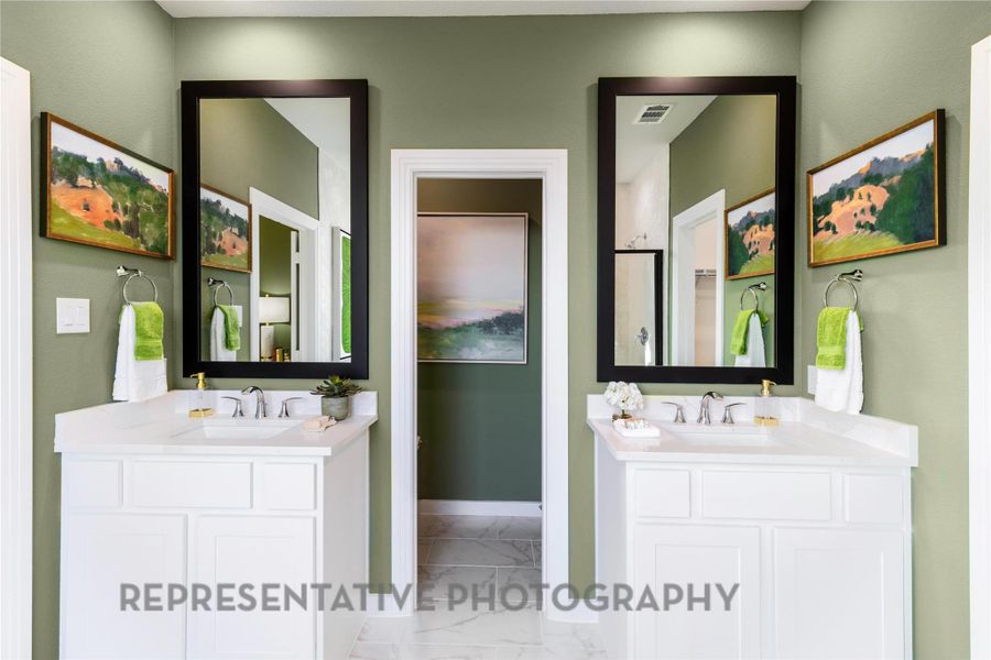 Bathroom featuring marble finish flooring and two vanities