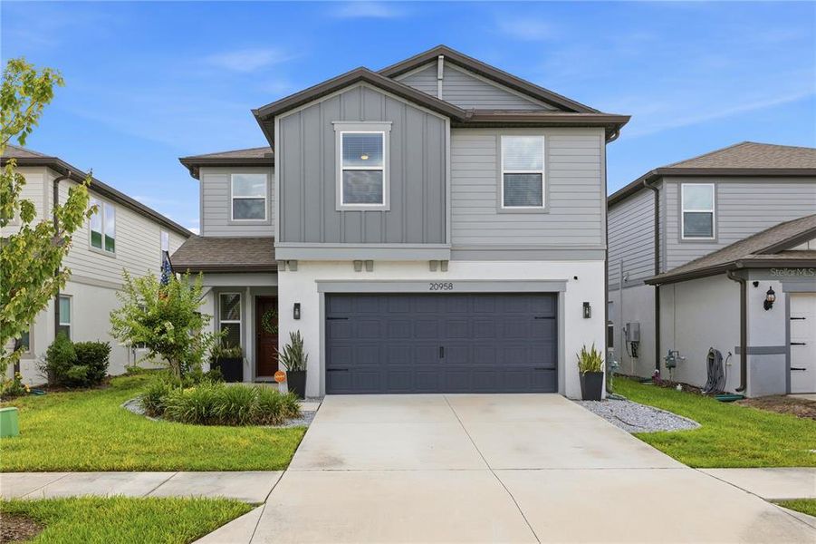 Front exterior of a new home in , Land O' Lakes, FL, highlighting curb appeal (Image 2). Front exterior of a new home in , Land O' Lakes, FL, highlighting curb appeal (Image 2).