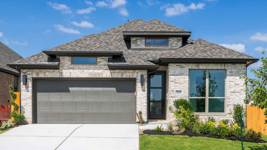 Front exterior of a new home in Lariat 45', Liberty Hill, TX, highlighting curb appeal (Image 8). Front exterior of a new home in Lariat 45', Liberty Hill, TX, highlighting curb appeal (Image 8).