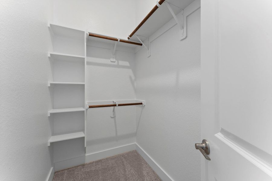 Closet in bedroom 2 with custom built-in shelves. Closet in bedroom 2 with custom built-in shelves.