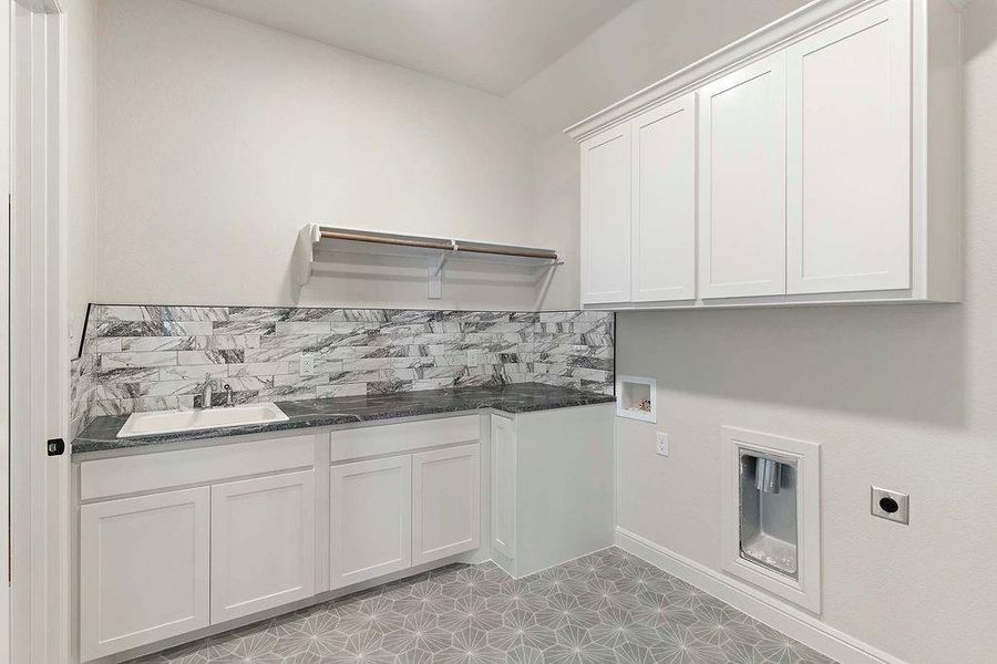 Laundry area featuring cabinet space, hookup for a washing machine, and electric dryer hookup