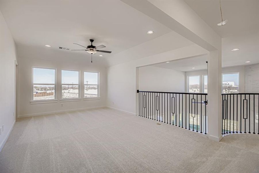 Empty room with a ceiling fan, light carpet, and recessed lighting