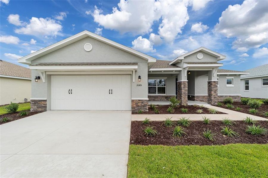 Front exterior of a new home in On Top of the World Communities, Ocala, FL, highlighting curb appeal (Image 1).