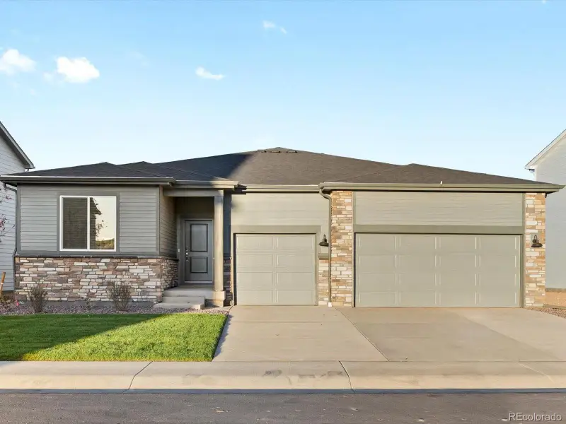 Front exterior of a new home in , Windsor, CO, highlighting curb appeal (Image 1).